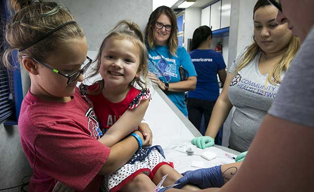 Children get vaccinated at a mobile clinic supported by Americares in Clute, Texas, in July. 
