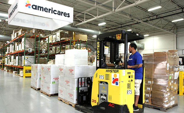 Workers at Americares distribution center in Stamford, Conn., prepare a shipment of relief supplies for survivors of the California Carr Fire. 
