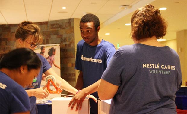 Nestlé Waters North America employees assemble first aid kits for Americares. Photo courtesy of Nestlé Waters North America.