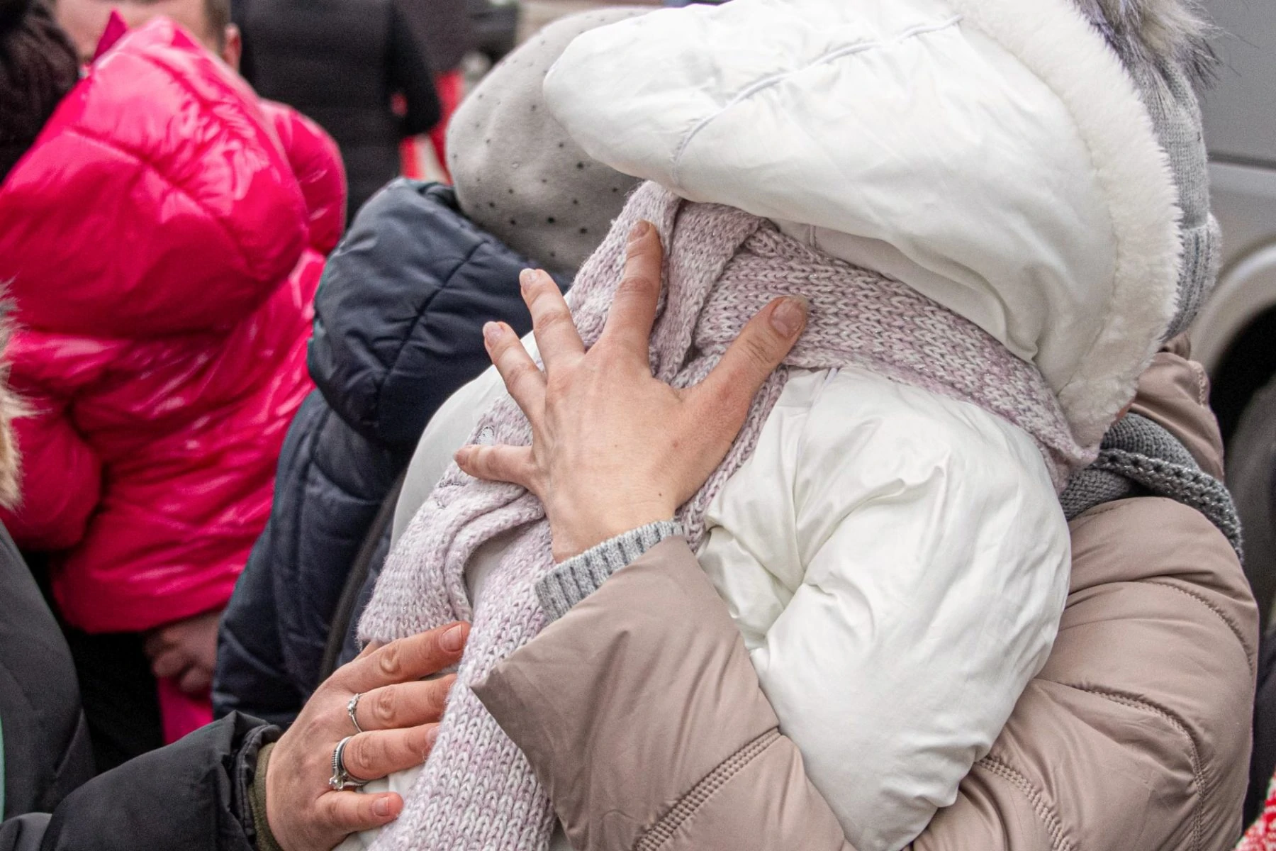 Two Ukranian refugees embrace
