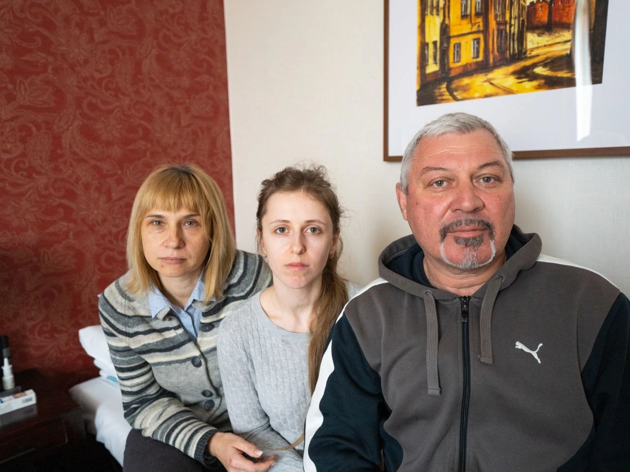 Alina (middle) poses for a photo with Olena (left) and Oleg (right), her mother-in-law and father-in-law, in a hotel in Krakow, Poland where she and her family are receiving displaced person’s assistance.