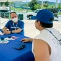 Americares staff member working with patient at mobile location,
