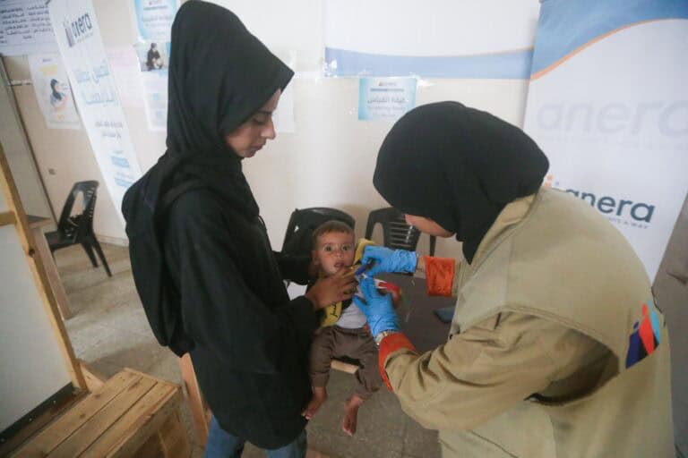 The clinic staff also monitors Nada's son's growth and prescribes supplements. (Photo Credit: Anera)