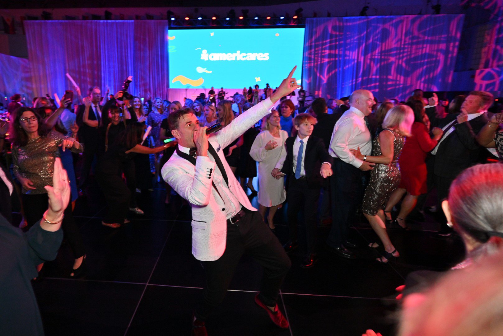 Guests dance at the 2022 Americares Airlift Benefit at Westchester County Airport on October 1, 2022 in Harrison, New York. Photo by Bryan Bedder/Getty Images for Americares.