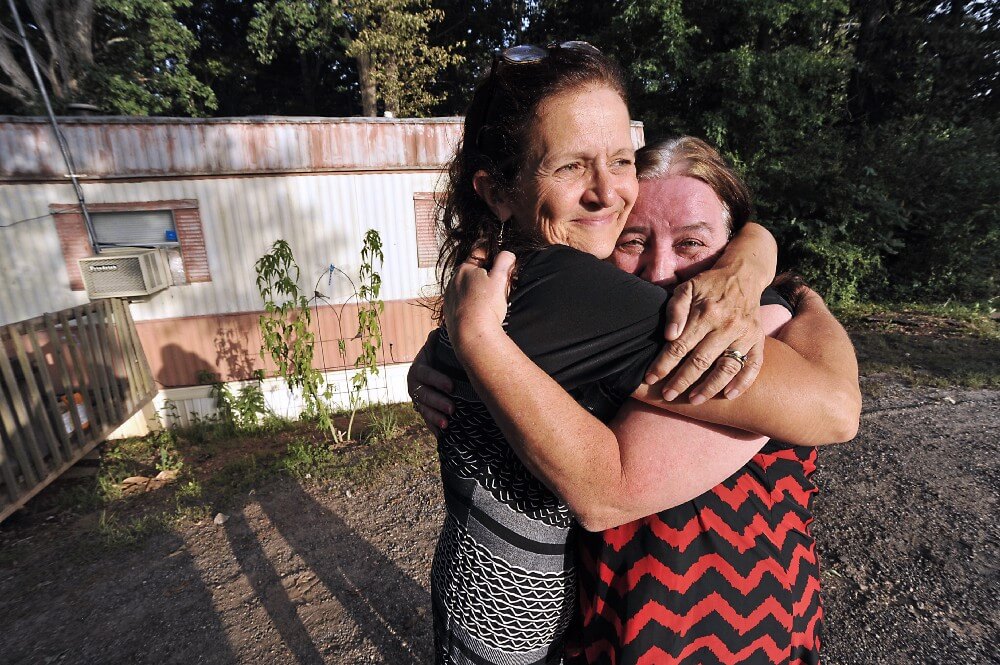 Here, a clinic director and her patient share a moment of goodness. Photo by Matthew McDermott.