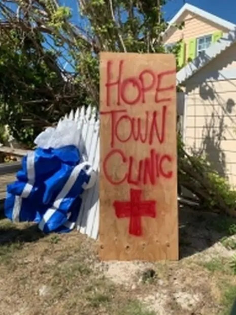 Temporary Hope Town Clinic sign made on plywood with red spray paint.