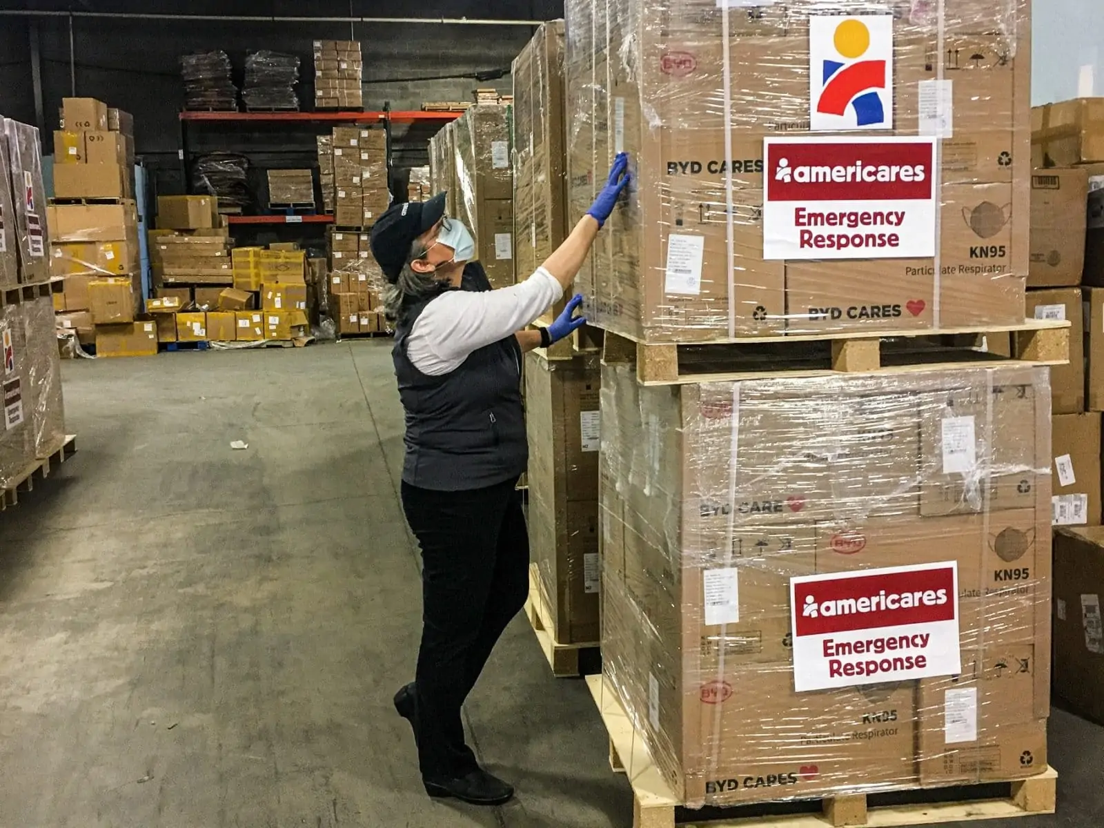 Americares Vice President of Global Program Operations Martha Kennard inspects a shipment of 300,000 KN95 masks for health workers in New York City. Photo courtesy of Americares.