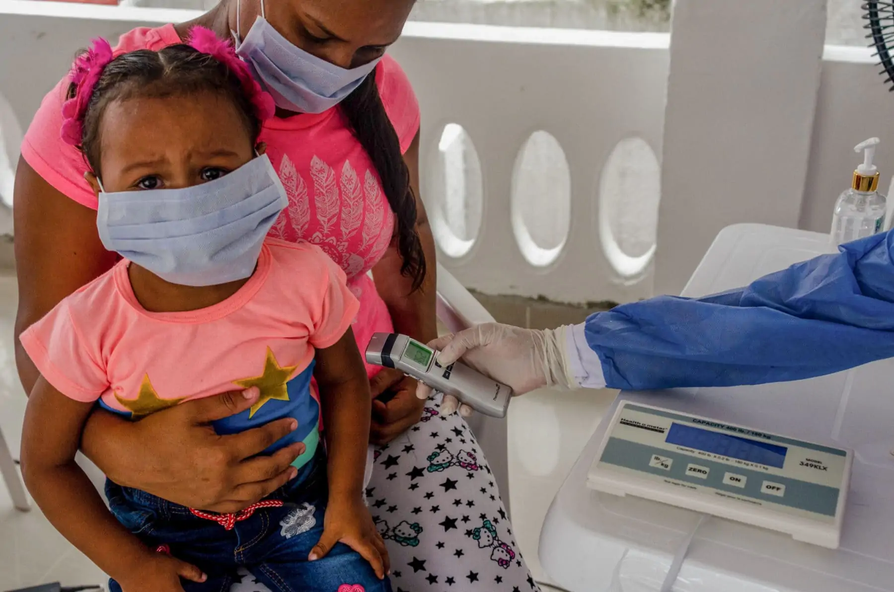 Doctor Cindy having a medical consultation with Mibian and her two-year-old daughter who is suffering from asthma. Barranquilla, Colombia,