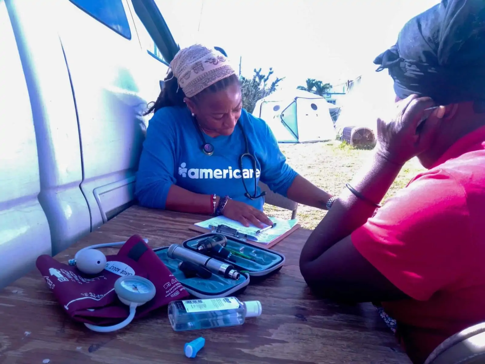 Americares's RN Geraldine Superville consulting with a patient.