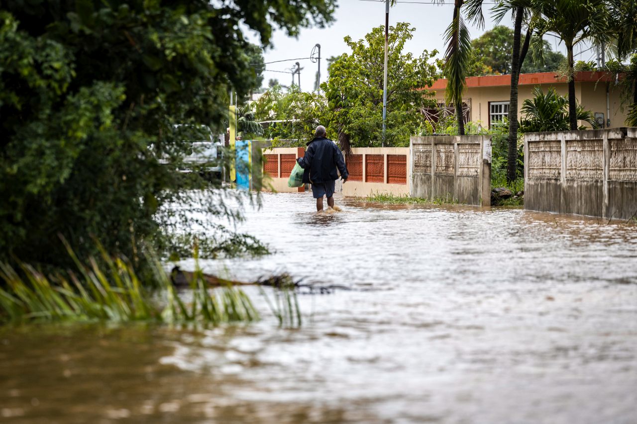 Woman walking away from camera in flooded street