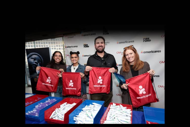 Volunteers from Creative Artists Agency (CAA) and Americares pack emergency go bags in Los Angeles, California, on the one-year anniversary of the Los Angeles wildfires on Jan. 7, 2026. (Photo by Tiffany Rose/Getty Images for Americares)