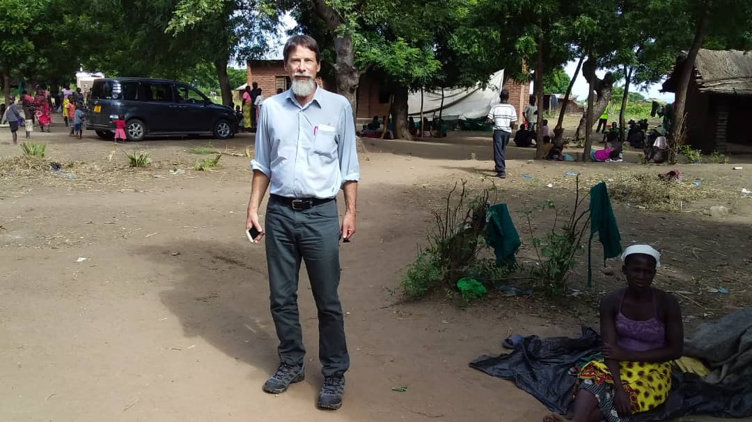 Adam Keehn on the ground at a school in Malawi housing displaced persons.
