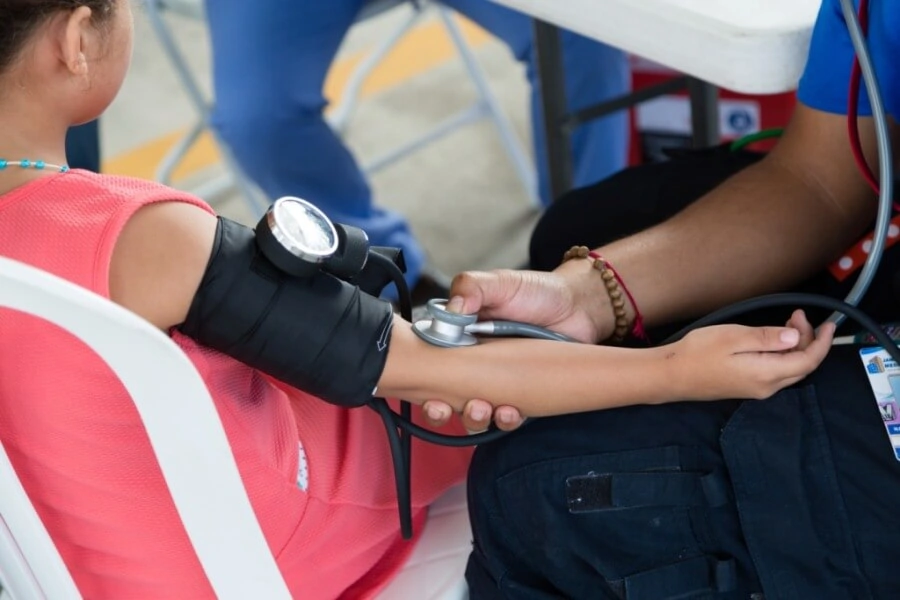 A close up photo of a child having her blood pressure taken.