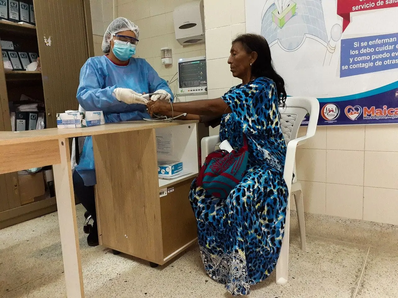 Nursing assistant taking blood pressure of patient at an Americares clinic in Colombia
