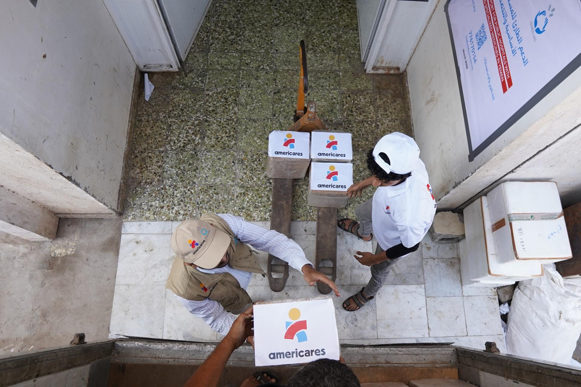 Yemen Aid staff unload boxes of essential medicines outside a health facility in Aden, Yemen, on March 15, 2026.